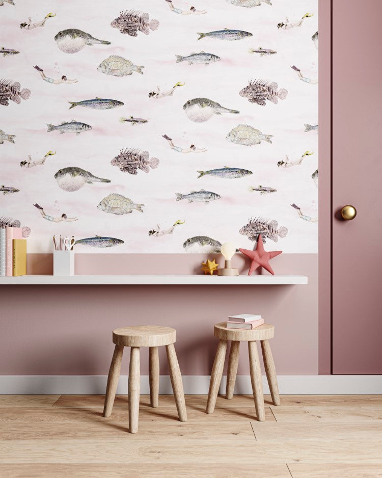 Classic Fish, Pattern Wallpaper in Pink creates a warm, modern room with wooden stools, books, a white shelf with decorative items, and a light wooden floor.