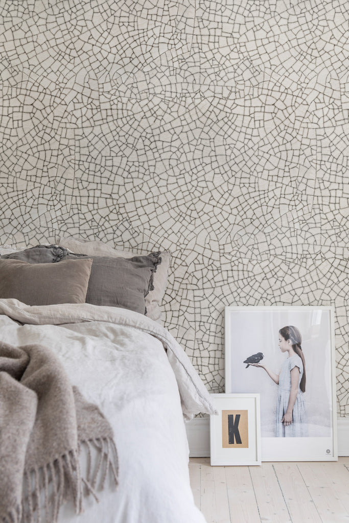 Crackle, Pattern Wallpaper featured on a wall of a bedroom with soft cushion and white bedsheets and brown fabrics and pillows