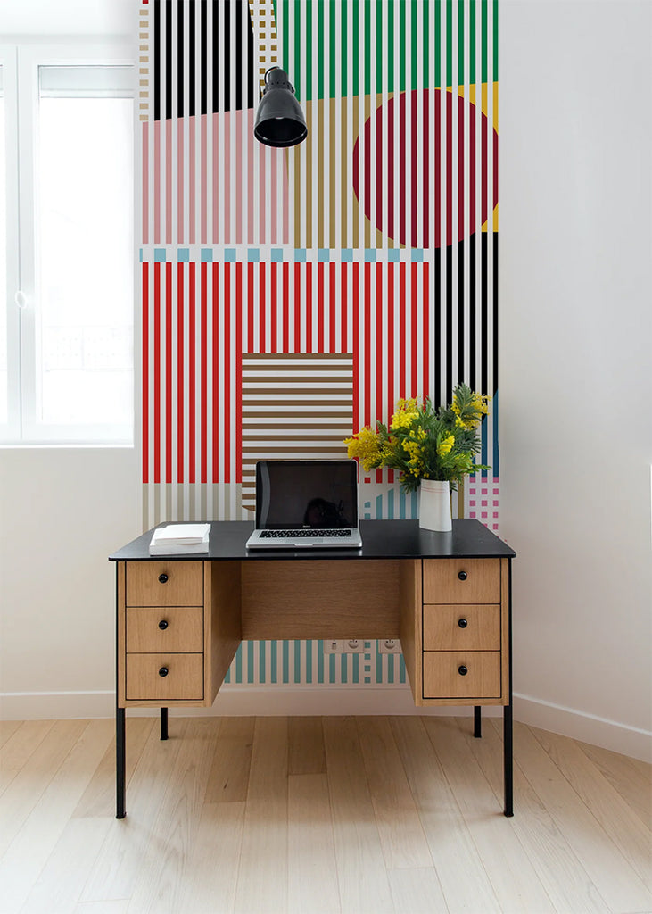 A vibrant room adorned with Diablo, Geometric Wallpaper, featuring a modern desk with a laptop, a book, and a vase of yellow flowers under a hanging lamp.