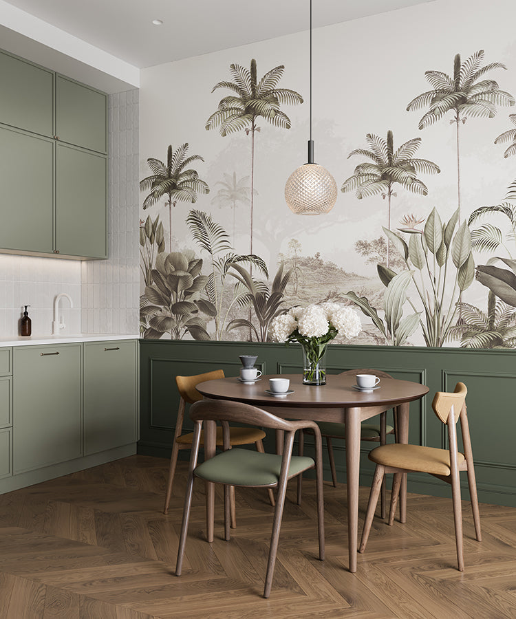 A modern, well-lit kitchen with green cabinets and a wooden dining set. The room is adorned with an Elegant Rainforest, Tropical Mural Wallpaper in Sand.