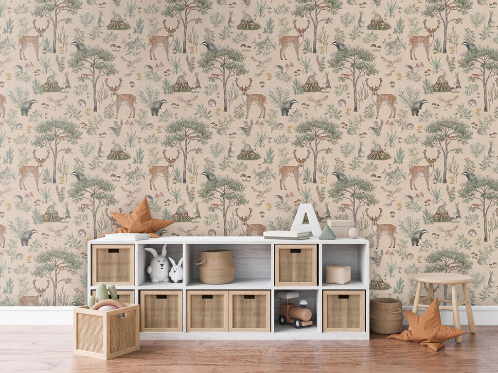 Fantastic Forest, Pattern Wallpaper in beige, the room includes a white storage unit with woven baskets, a star-shaped cushion, a letter 'A,' and some books. Additionally, there is a wooden stool with another star-shaped cushion and a basket of toys on the floor. The room has a cozy wooden floor.