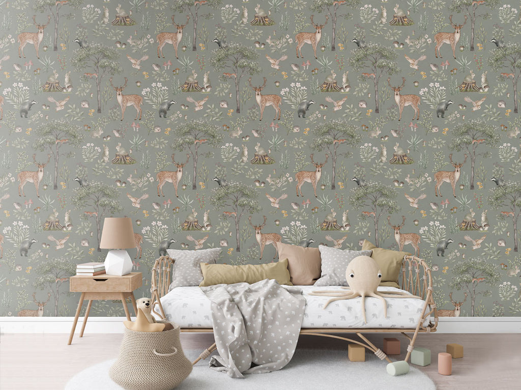 Fantastic Forest, Pattern Wallpaper in green colourway. The room features a cozy reading nook with a comfy armchair, a small wooden bookshelf filled with children's books, and a soft, patterned rug.