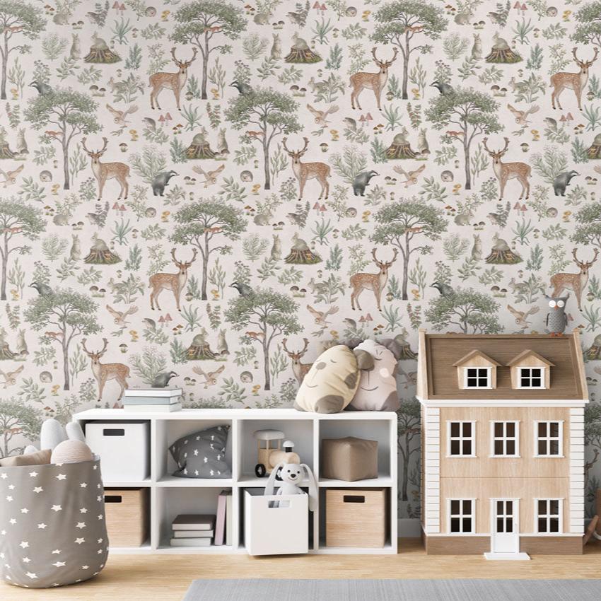 Fantastic Forest, Pattern Wallpaper in white, the children's room includes a white storage unit with cubbies containing toys, books, and storage bins. On top of the storage unit, there are plush toys, a small wooden house, and a decorative owl. A string of star-shaped decorations hangs down on the right. A grey storage basket with white stars, filled with plush toys, adds to the playful and organized atmosphere.