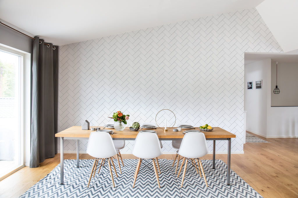 Fishbone Lines, Pattern Wallpaper featured on a wall of a dining area with wooden table and white chairs