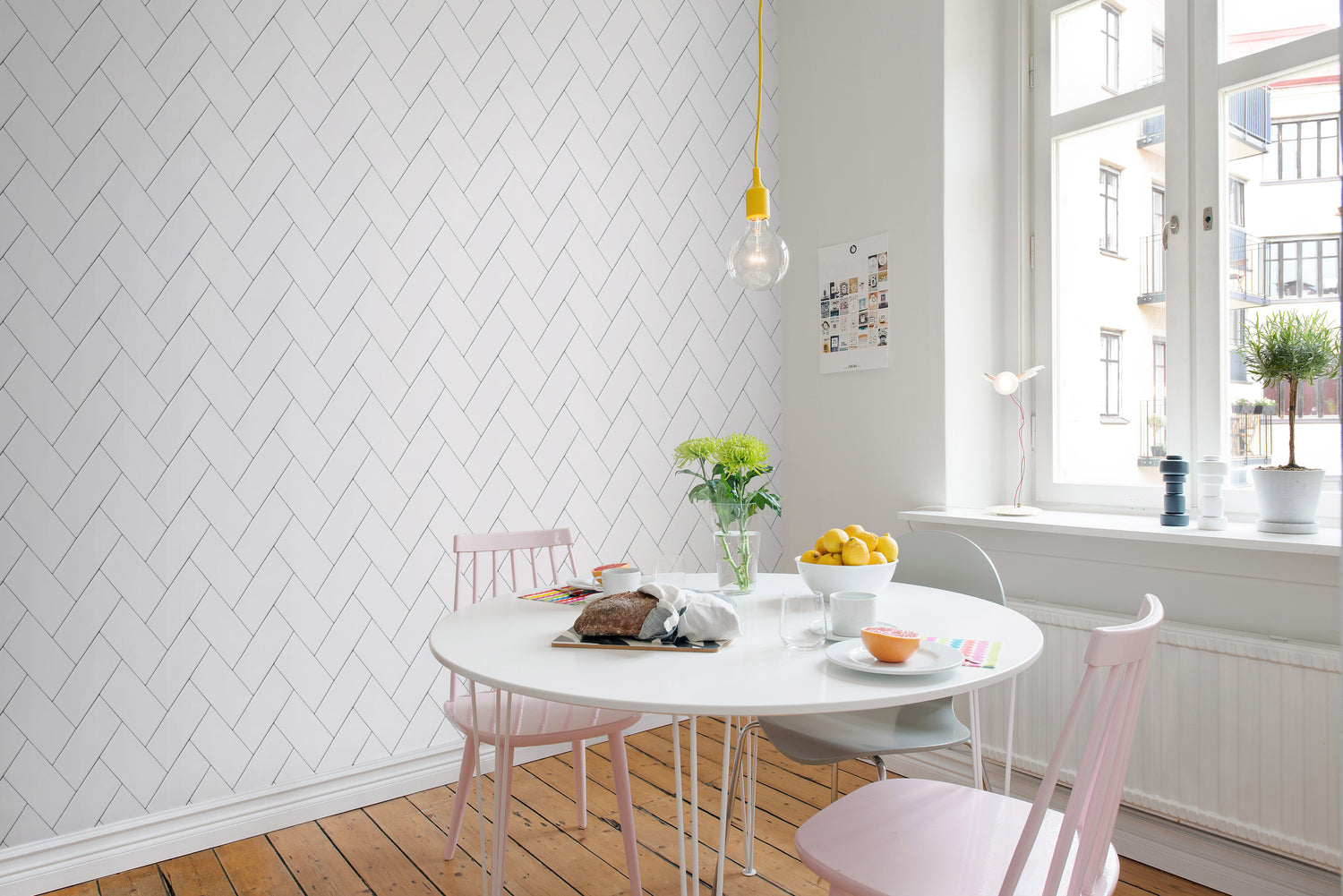 Fishbone Lines, Pattern Wallpaper featured on a wall of a dining area with round white dining table and pink chairs