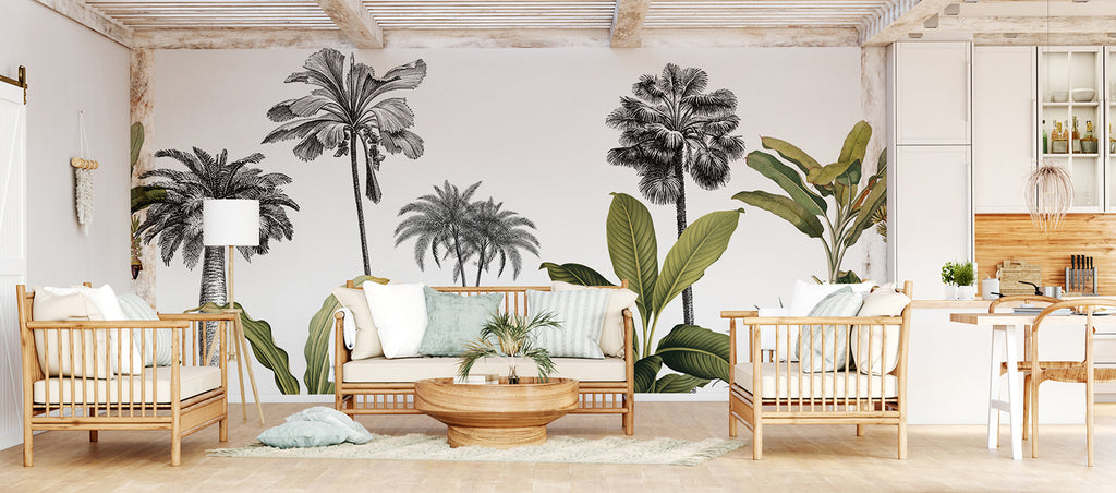 A tranquil room adorned with Forest Dreams, Mural Wallpaper, featuring a cozy seating area with beige sofa, wooden armchairs, and a coffee table. The open kitchen shelving and dining area in the background add functionality to the space.