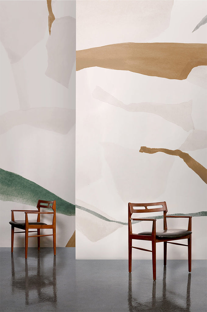 Fracture, Abstract Mural Wallpaper in Clay featured on a wall of a room with wooden chairs