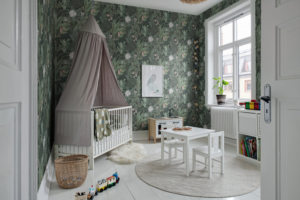 Furada Floral & Toucan, Pattern Wallpaper featured in dark green colourway in a children’s room surrounded by toys and table and chair furnitures for kids