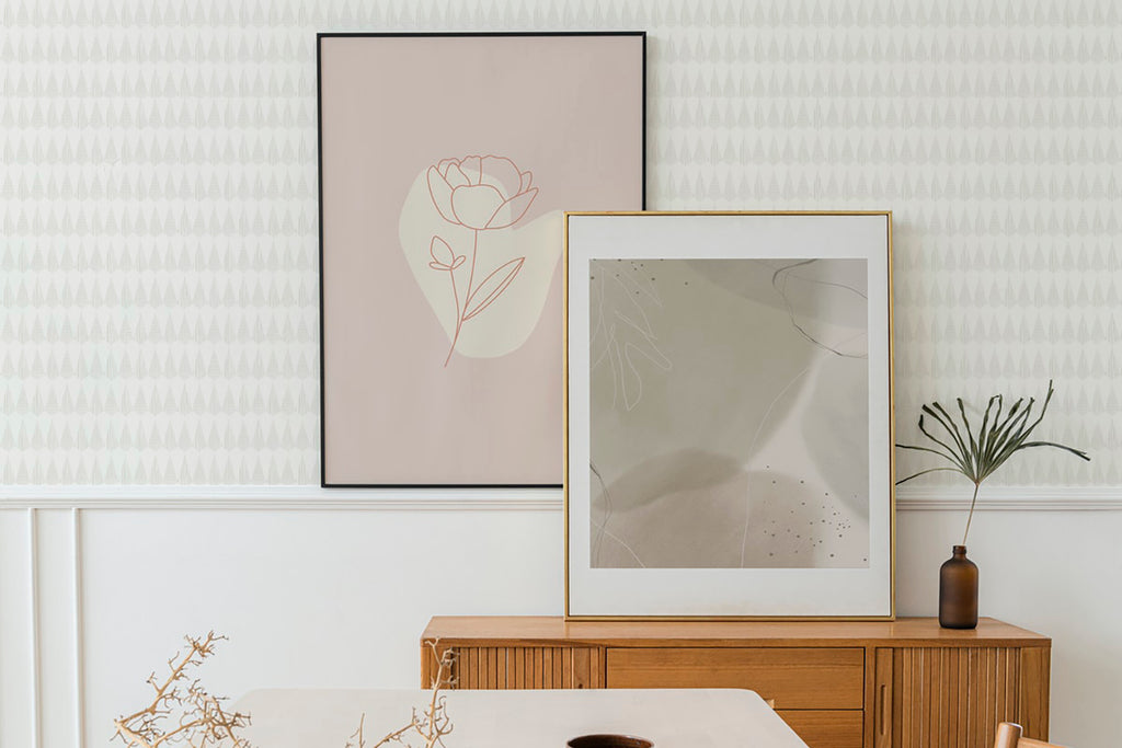 A cozy room with Geometric Panorama pattern wallpaper, featuring a wooden desk with dried plants, two minimalist floral artworks, and a modern vase with greenery.