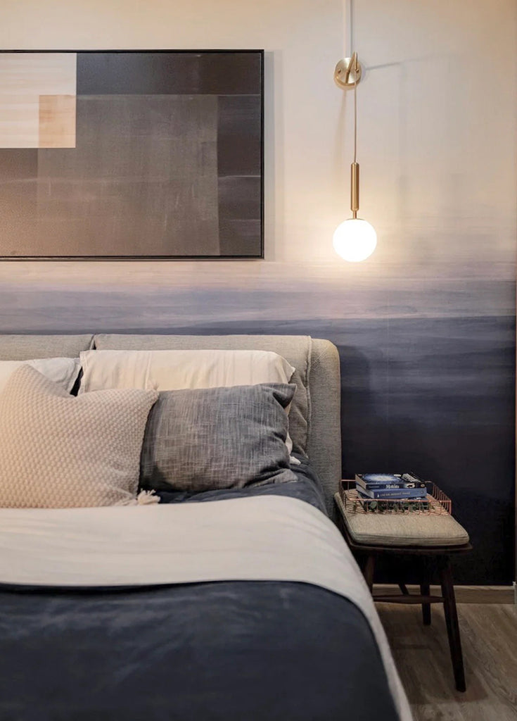 A serene bedroom showcasing the Gradient Ombre Mural Wallpaper. The wall transitions from a light shade at the top to a darker hue at the bottom, enhancing the room’s modern decor.