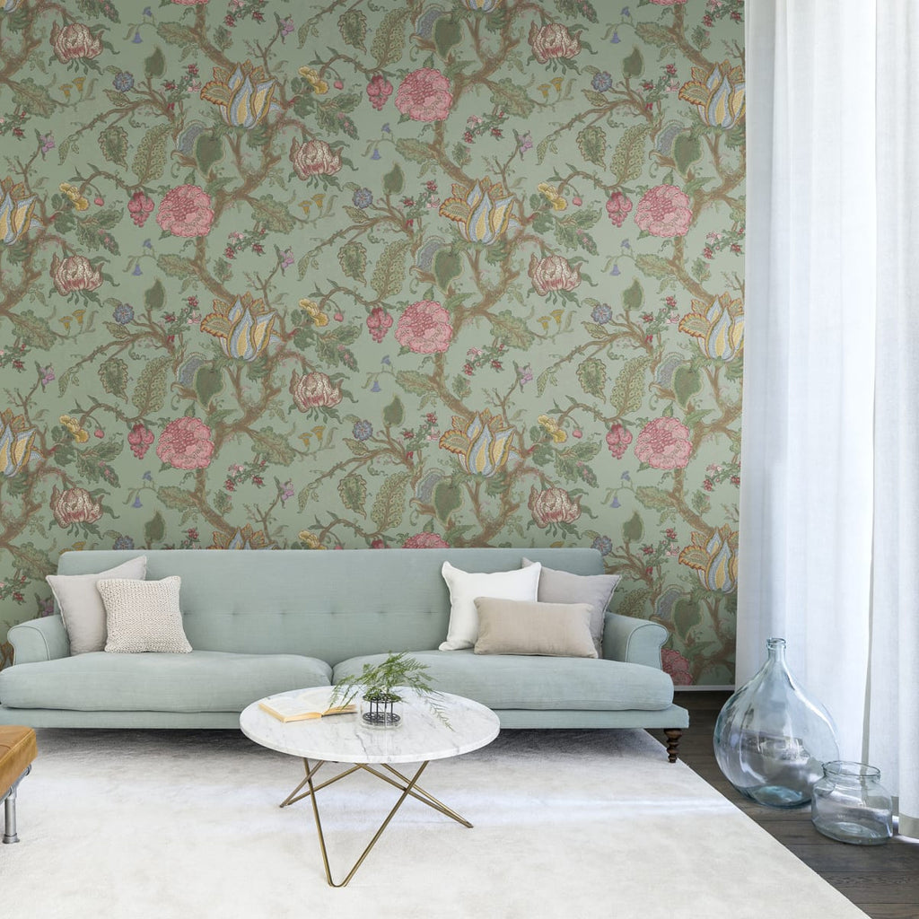 Growing Wilderness Floral, Wallpaper featured on a wall of a dining area with white round table and pink chairs