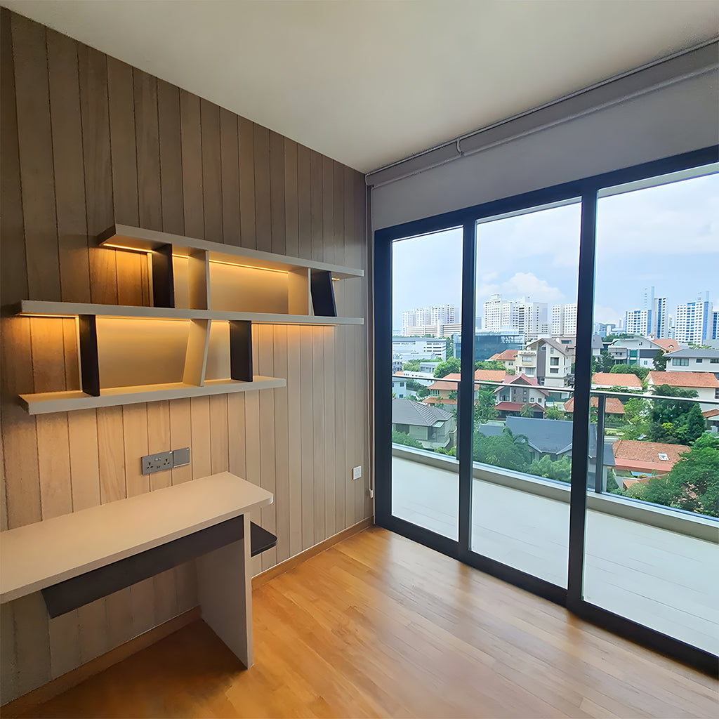 The empty study room with shelves and study table. The warm wall light adds warmth to the space.