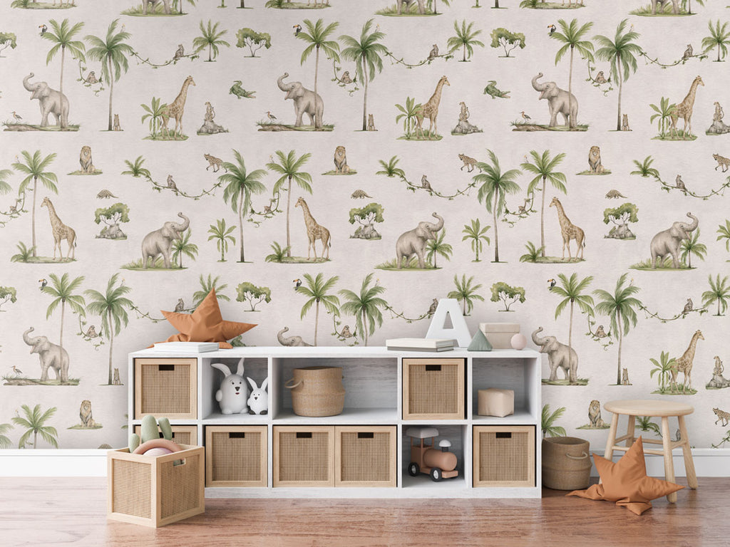 Joyful Jungle, Pattern Wallpaper in a white, the room includes a white storage unit with woven baskets, a star-shaped cushion, a letter 'A,' and some books. Additionally, there is a wooden stool with another star-shaped cushion and a basket of toys on the floor. The room has a cozy wooden floor.