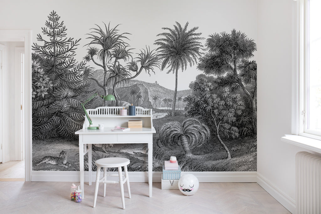 Jungle Land, Mural Wallpaper in Stratos Grey featured on a wall of a kid’s room with white study table and stool with toys around it