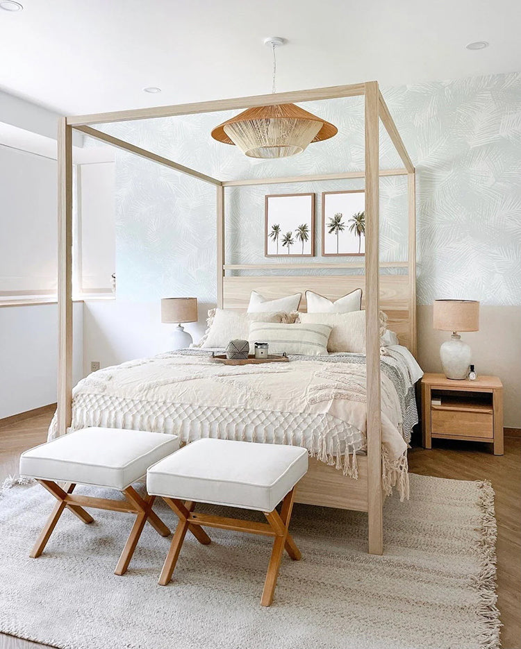 Cozy, well-lit bedroom with modern decor, featuring a four-poster bed, white stools, wooden nightstand, Tropical Pattern Wallpaper in Green