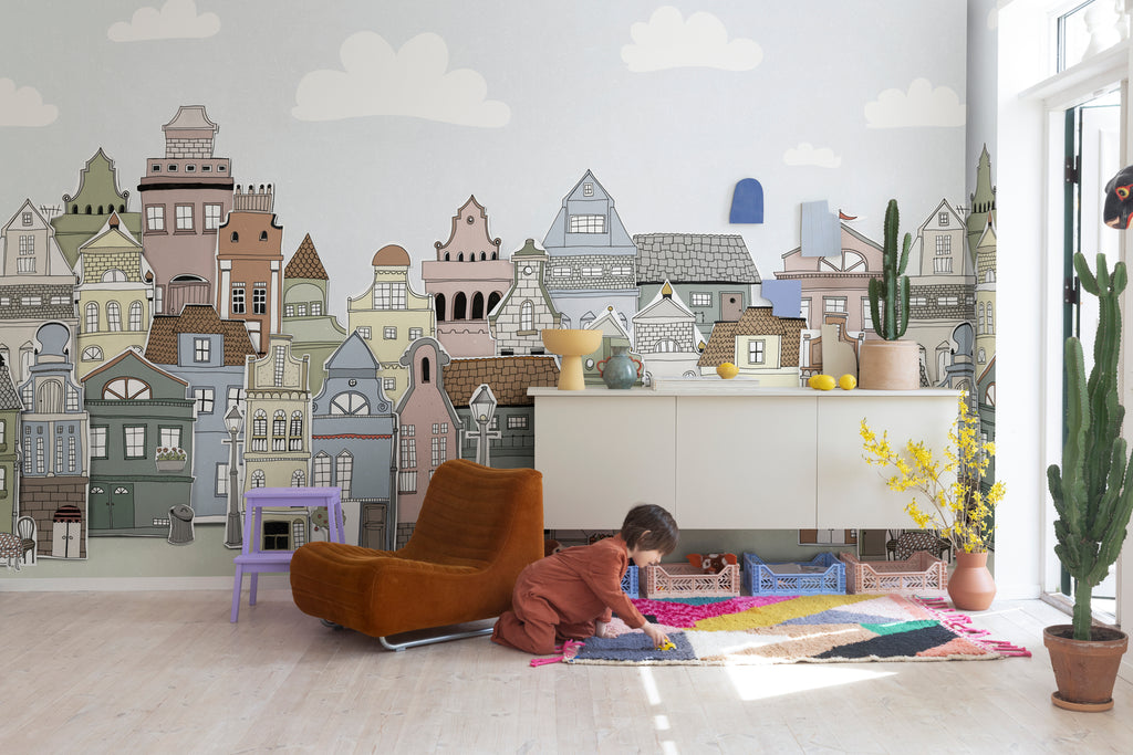 London Houses, Mural Wallpaper in summer featured on a wall of a kid’s room with multicolored floor mat and child-friendly furnitures with wooden flooring