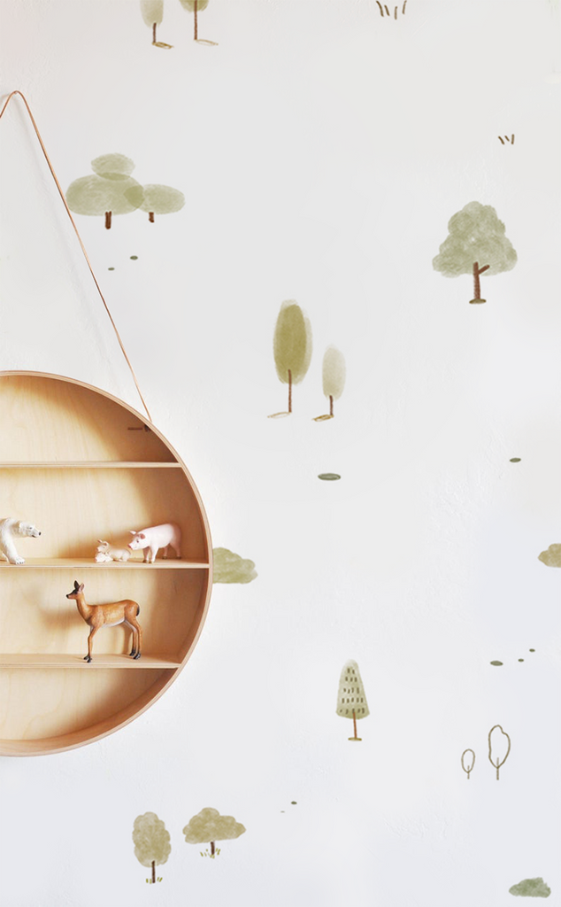 A Mini Timberland, Pattern Wallpaper in Green featuring stylized trees, clouds, and deer in soft colors. A unique boat-shaped shelf adds a 3D aspect to the design.