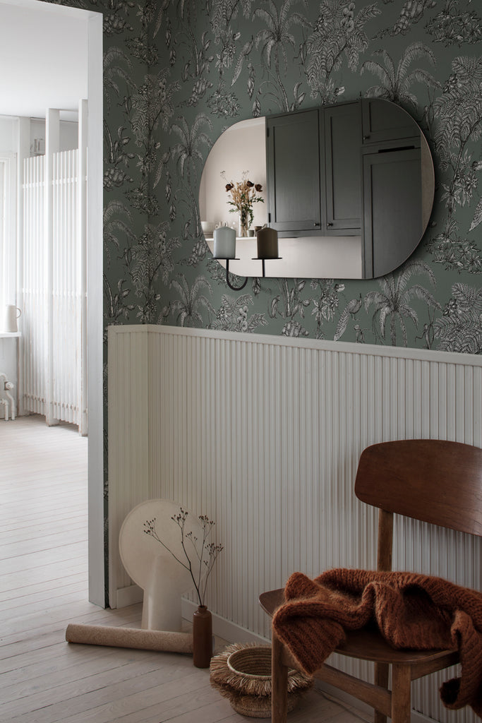 Moa, Tropical Pattern Wallpaper in green featured on a wall of a hallway with mirror on it and a wooden chair along the way