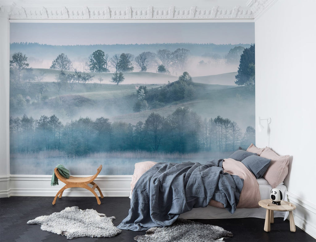 Morning Haze, Blue Landscape Wallpaper featured on wall of a bedroom with pink bed and pillow and blue bed sheet