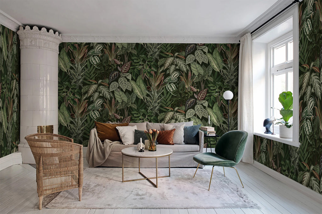 Night-time Jungle, Tropical Mural Wallpaper in forest green featured on a wall of a living area with sofa that has multiple colored pillows, a round table and living room furnitures