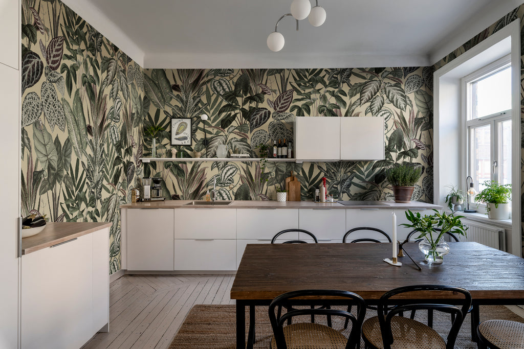 Night-time Jungle, Tropical Mural Wallpaper in sand featured on a wall of a kitchen and dining area with brown dining table and white countertops 