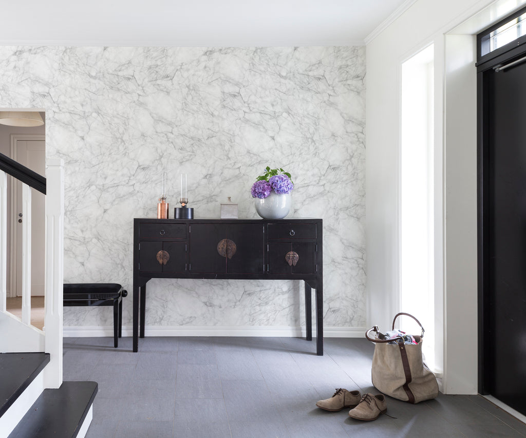 Noble Marble, Grey Wallpaper featured on a wall of a foyer with dark brown flooring and a black cabinet