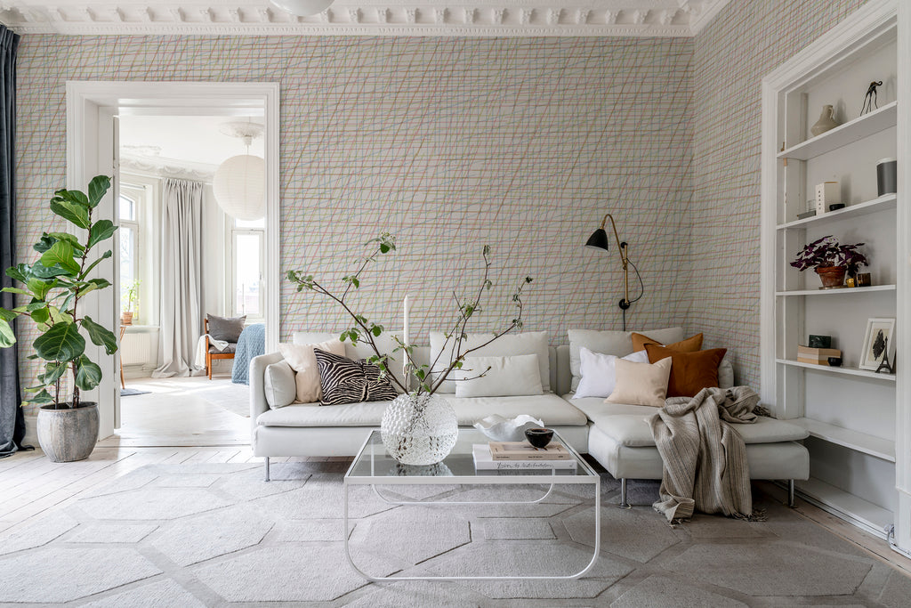 Note Sheets, Pattern Wallpaper featured on a wall of a bedroom with a living area with white sofas, multicolored pillows and sheets and glass table 