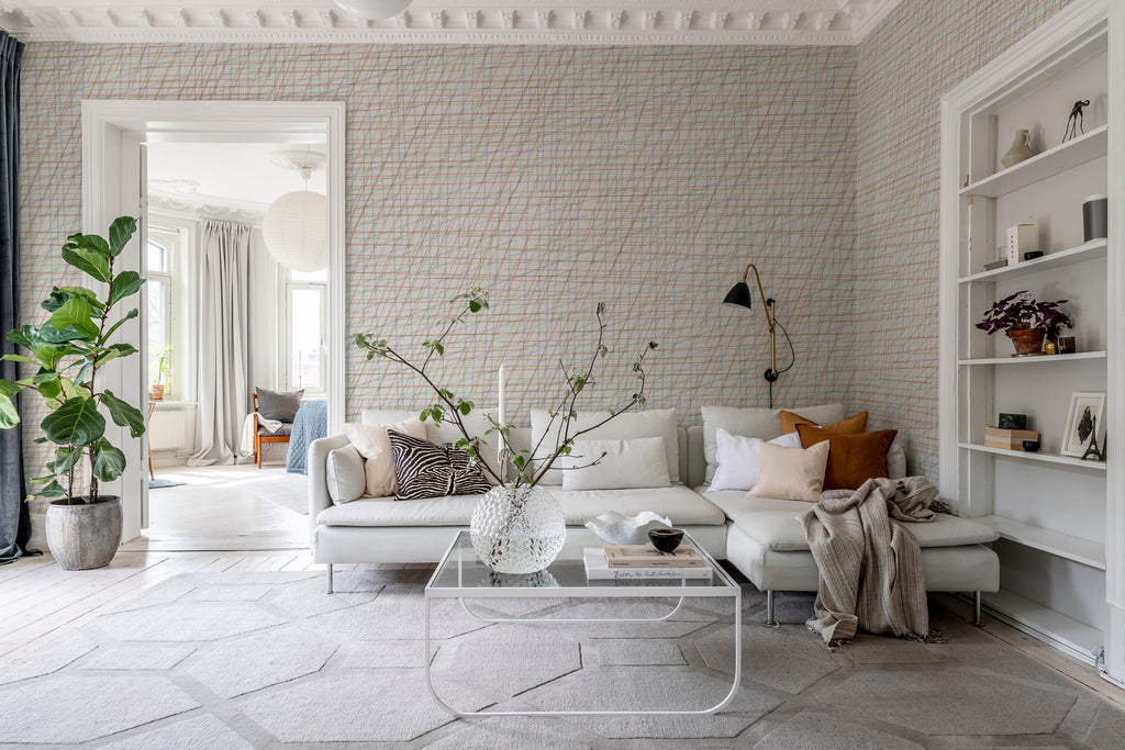 Note Sheets, Pattern Wallpaper featured on a wall of a bedroom with a living area with white sofas, multicolored pillows and sheets and glass table 