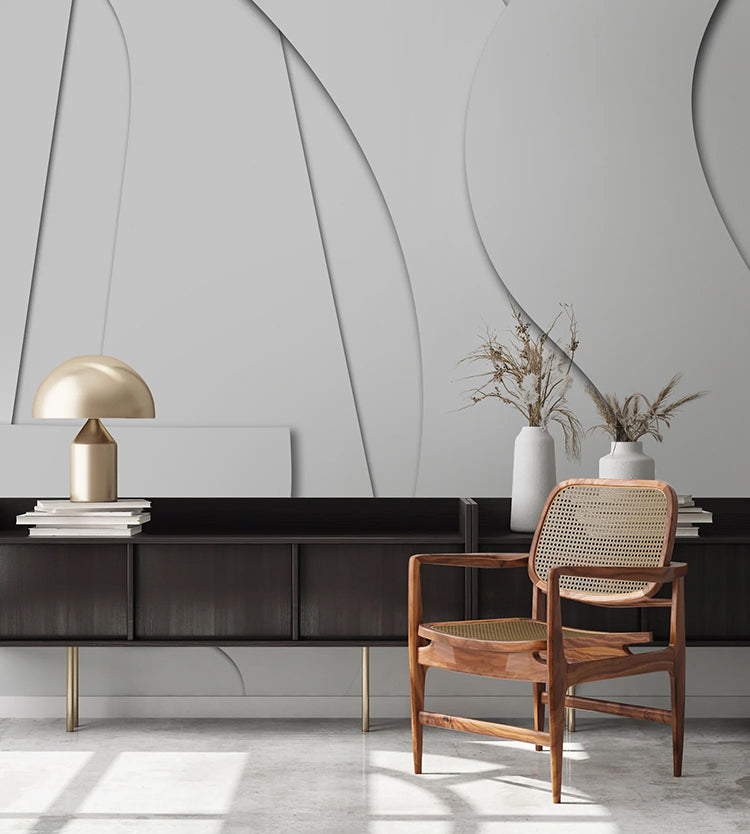 A modern, minimalist room featuring a sleek, dark console table, a woven chair, and a golden dome lamp. The room’s aesthetic is enhanced by the Offcut Shapes, Geometric Wallpaper.