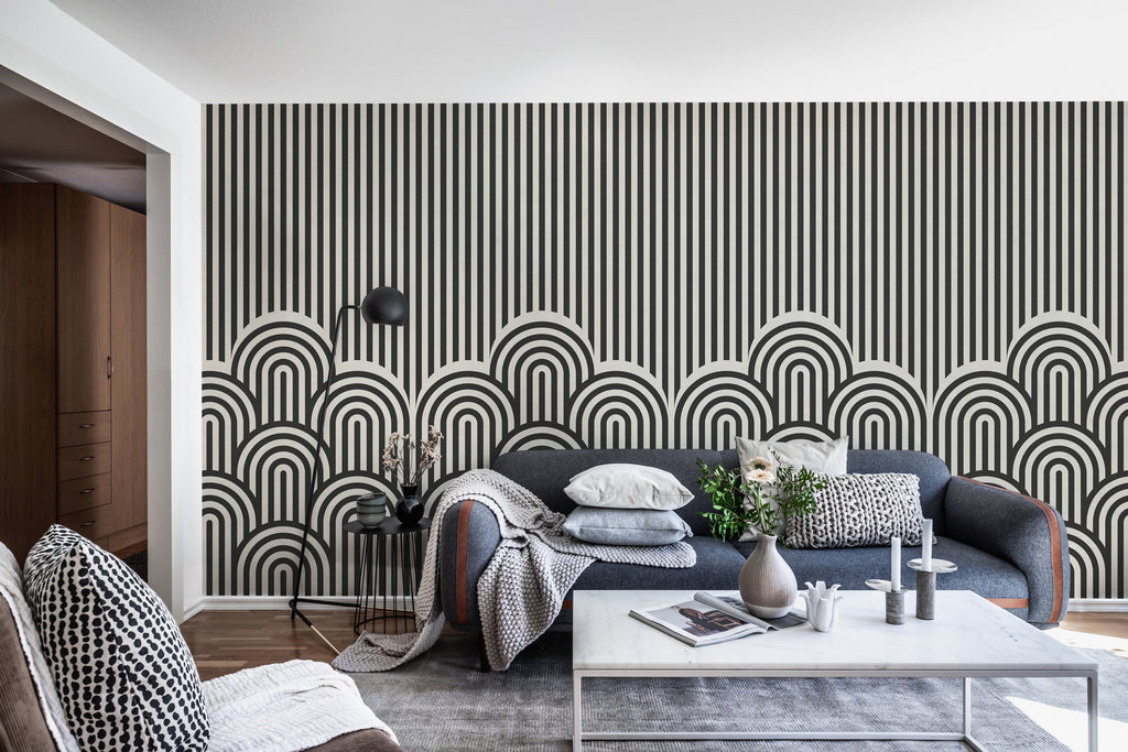 On the Dunes, Geometric Wallpaper in Dark Grey featured on a living area with grey sofas and white table with vases and candle 