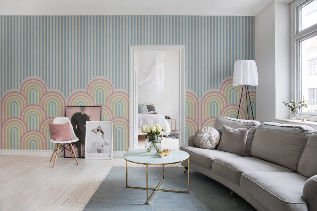 On the Dunes, Geometric Wallpaper in multicolor featured on a wall of a living area with grey sofa and round table with flower on it