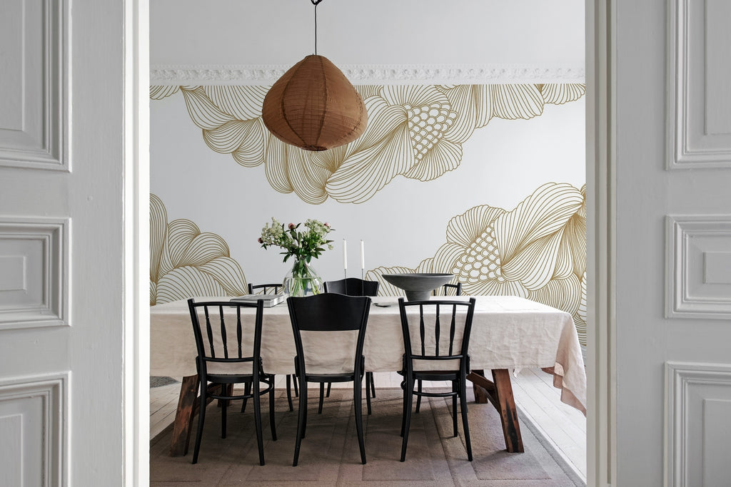 Opulent Beauty, Wallpaper in Gold featured on a wall of a dining area with a long dining table in white cloth on top, candle lights, and kitchen wares and black chairs