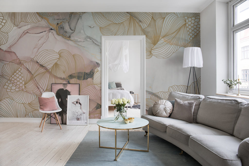Opulent Beauty, Wallpaper in nude featured on wall of a living area with grey fabric sofa with multiple pillows and a round table with flowers on top