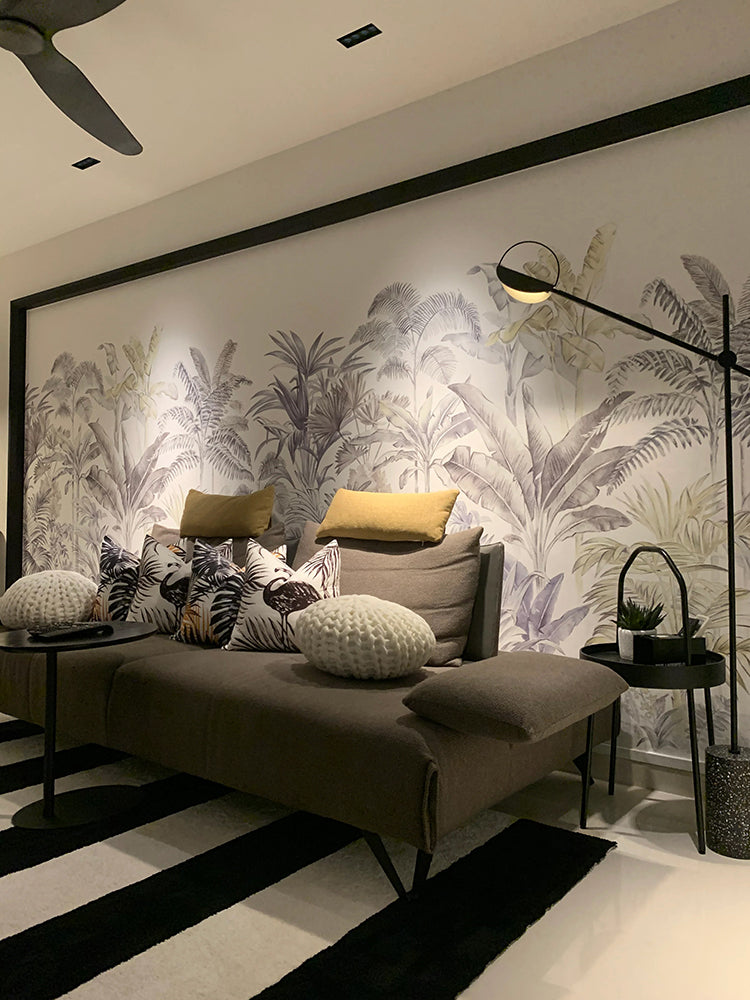 Contemporary room with a Palm Garden, Tropical Mural Wallpaper,  featuring a sleek chaise lounge on a striped rug, a modern lamp on a side table, and a ceiling fan above.
