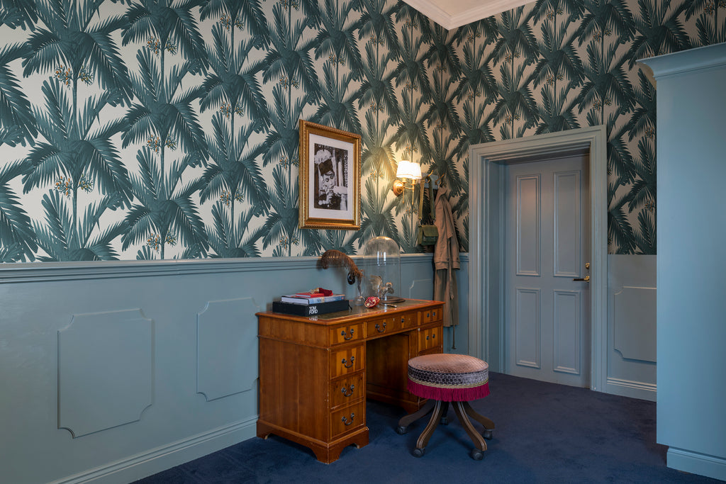 Palm Spring, Tropical Pattern Wallpaper in Turquoise in the wall of a hallway with wainscotting effects.