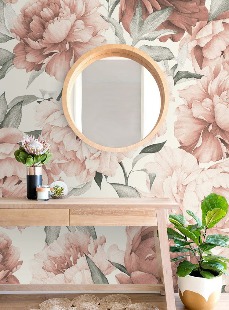 Peonies Garden, Floral Pattern Wallpaper in Crimson, featuring large crimson peonies and pastel green leaves on a light background. A wooden mirror and console table with potted plants accentuate the serene ambiance.