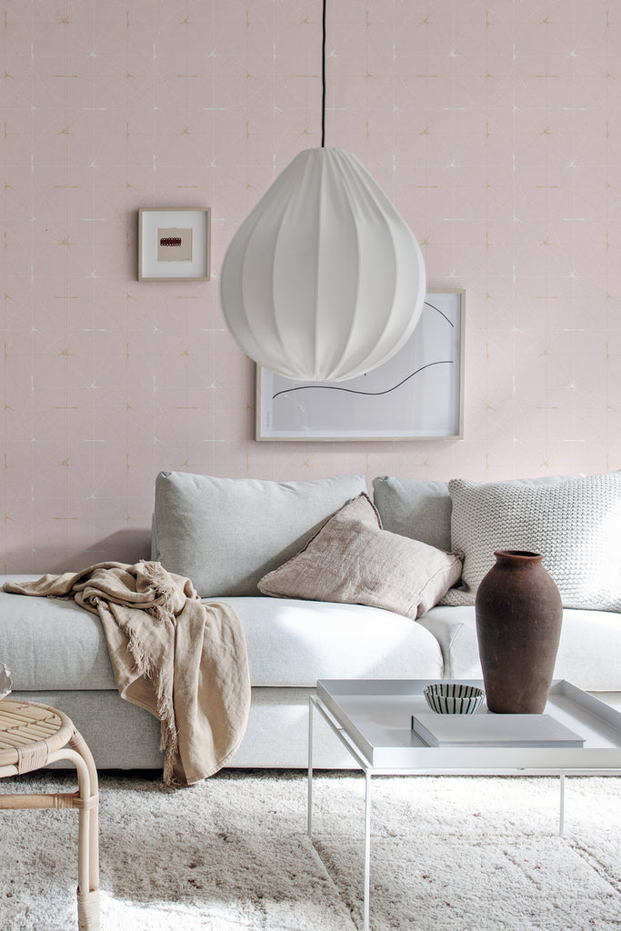 Perfect Fit Powder Pink, Pattern Wallpaper, featured on a wall of a a living area with fabrics and brown jar as decoration
