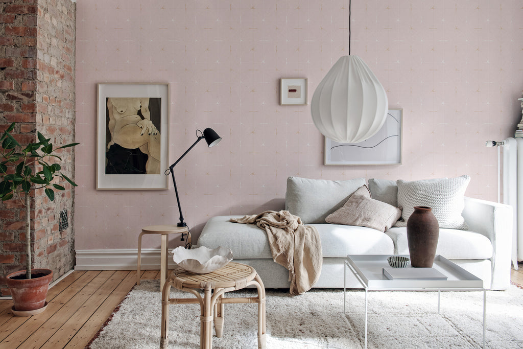 Perfect Fit Powder Pink, Pattern Wallpaper, featured on a wall of a a living area with fabrics and brown jar as decoration