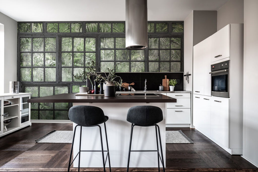 Perspective Garden, Mural Wallpaper in black featured in a wall of a modern kitchen and dining area, seen in the image is a countertop with brown tiles with its black stools