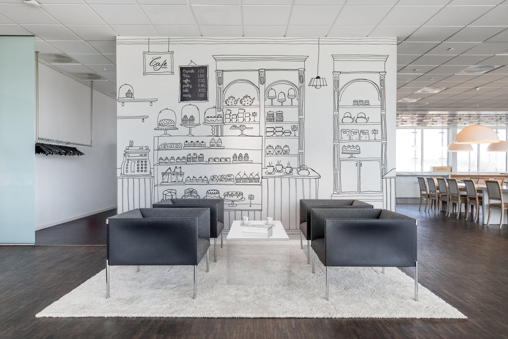 Petite Bakery, Mural Wallpaper featured on a wall of a living area with black leather sofa set and white carpet and dark wood flooring