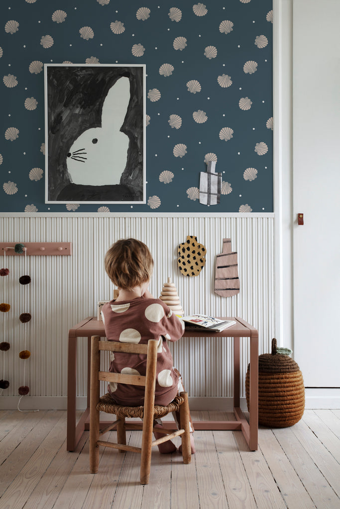 Picking Seashells, Wallpaper in Blue Featured on a wall of a kid’s study room with a wooden study table, and wooden flooring