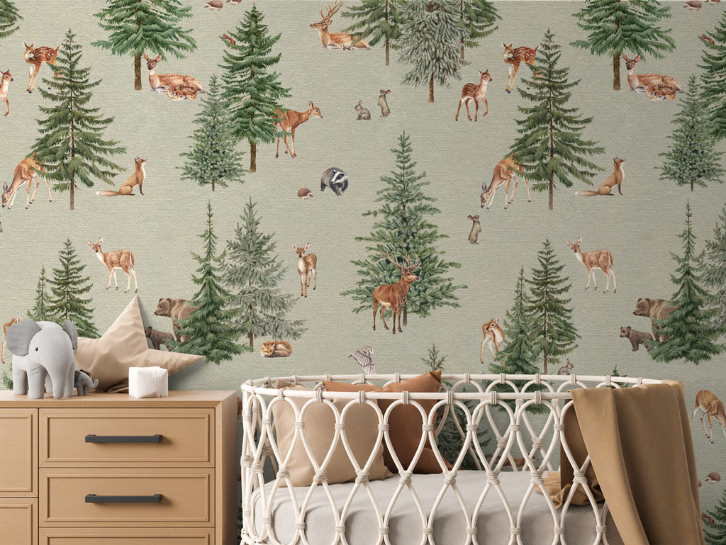 Pine forest, Pattern Wallpaper in green colourway. The nursery room includes a wooden dresser with an elephant plush toy, and a crib with a brown blanket.