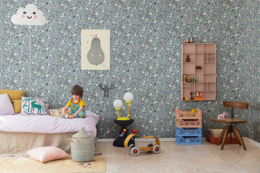 Pixie, Floral Pattern Wallpaper, in light blue, featured on a wall of child's bedroom with lightlamp and wall shelf.