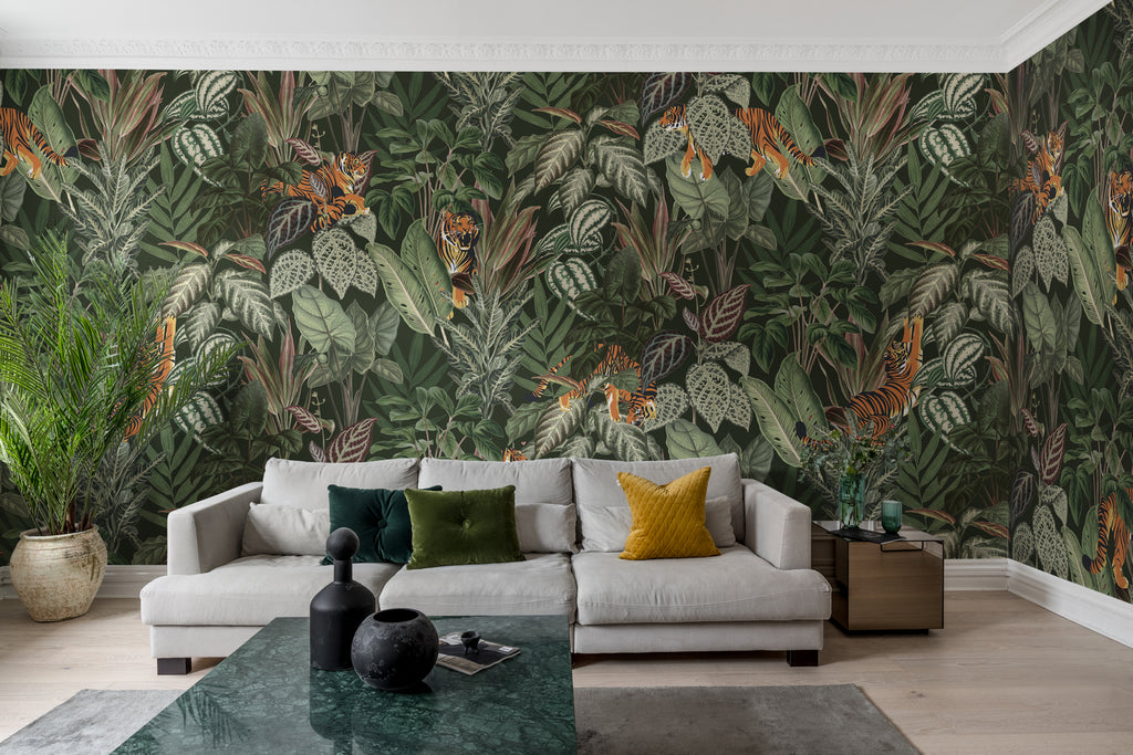 Playful Tiger, Pattern Wallpaper in forest green colourway featured on a wall of a living area as seen with grey sofa and multi colored pillows and jade rectangular table that as ceramics on top