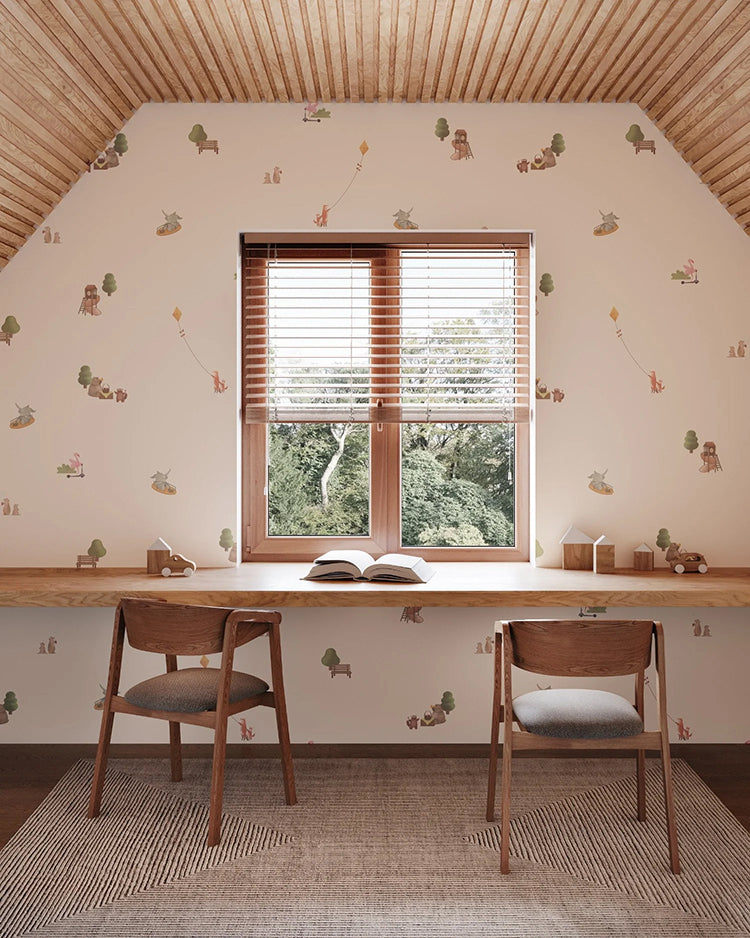 A serene study space with Playground, Animal Patterned Wallpaper. Features a large window, two chairs, a desk with an open book, and a striped rug.