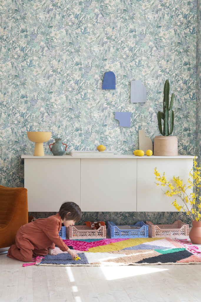 Closed up, Poppy Meadow, Floral Pattern Wallpaper in Light Blue as seen in a child’s playroom with colourful vases and toys