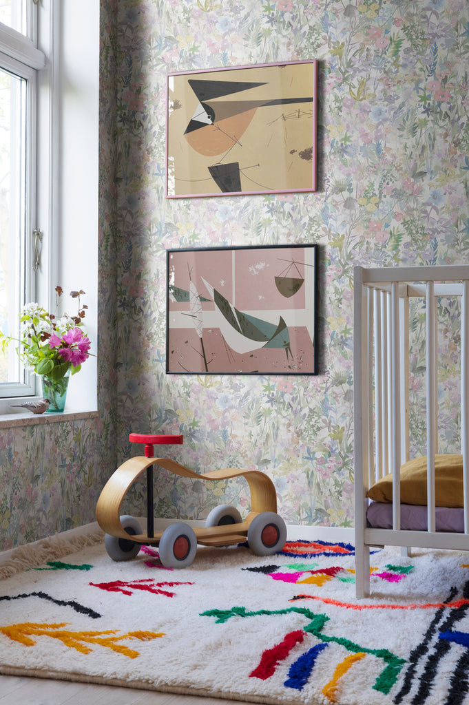 Poppy Meadow, Floral Pattern Wallpaper in Pink as seen in a cozy living area with framed art and colourful furniture