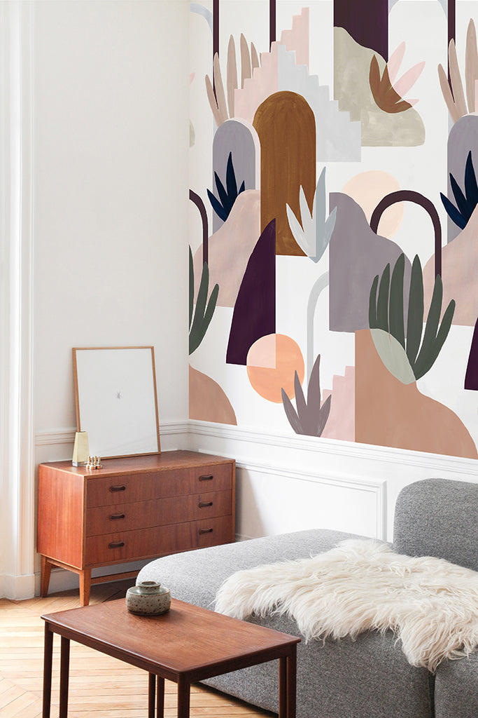Ressa, Abstract Geometric Wallpaper, enhances a cozy room’s modern aesthetic. Pastel tones mix with bold shapes. A wooden dresser and comfy sofa add charm.”