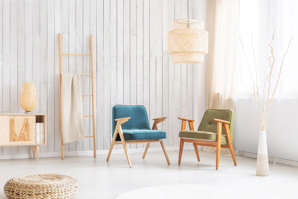 A tranquil room adorned with Rustic White Panels, Striped Wallpaper highlighted by a pair of mid-century modern armchairs in soothing blue and green. A wooden ladder and sideboard add a touch of rustic charm, while decorative branches in a vase contribute to the serene ambiance. The room is bathed in soft, natural light, enhancing its calm and inviting atmosphere.