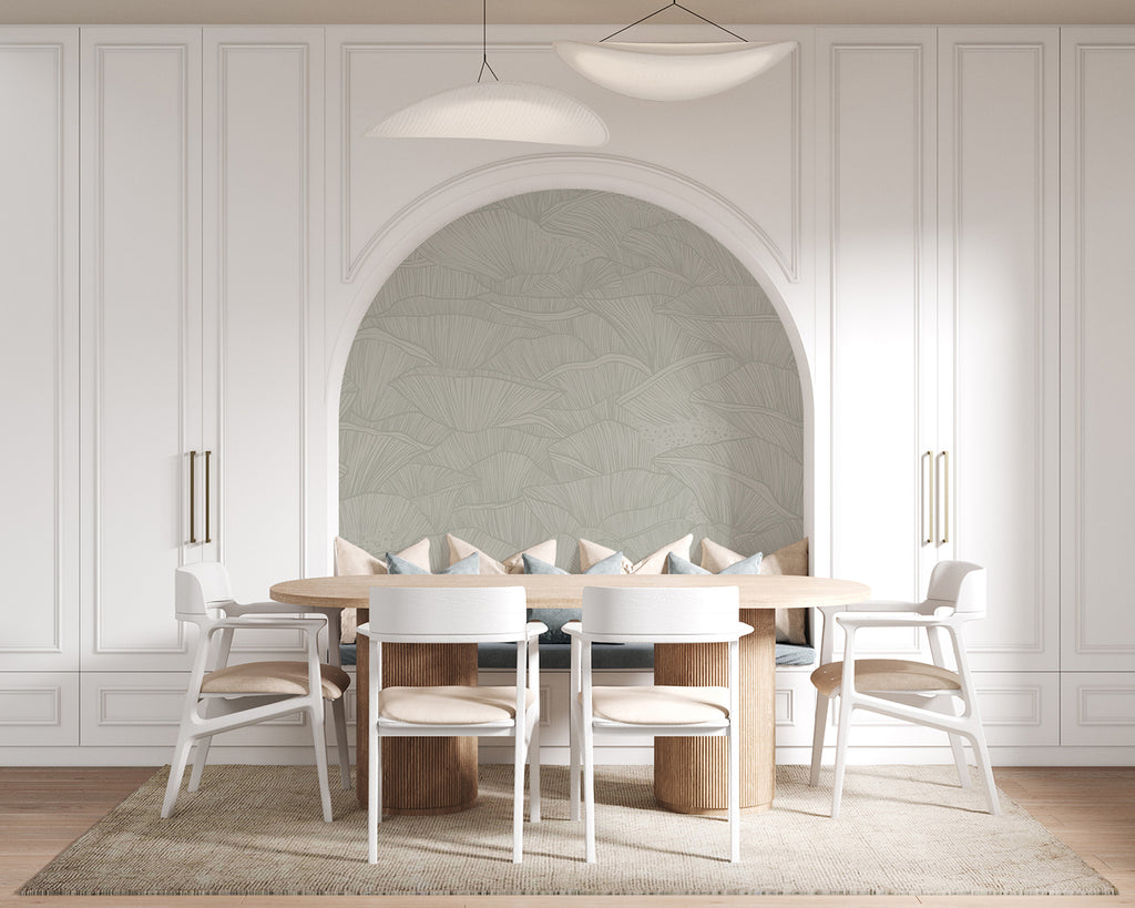 A modern, spacious dining room featuring an arched alcove, a large wooden table with white chairs, a sleek floor lamp, and a unique light fixture. The room’s elegance is enhanced by the Saltwater Ripples, Pattern Wallpaper in Green.